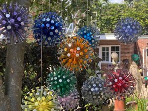 Floating Allium Sculpture hanging in tree made to mimic real allium