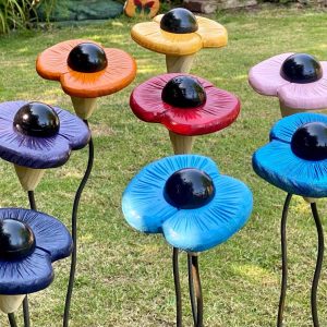 8 OF OUR POPPY SCULPTERS, each one made from wood with metal stems made to mimic the look of a real poppy