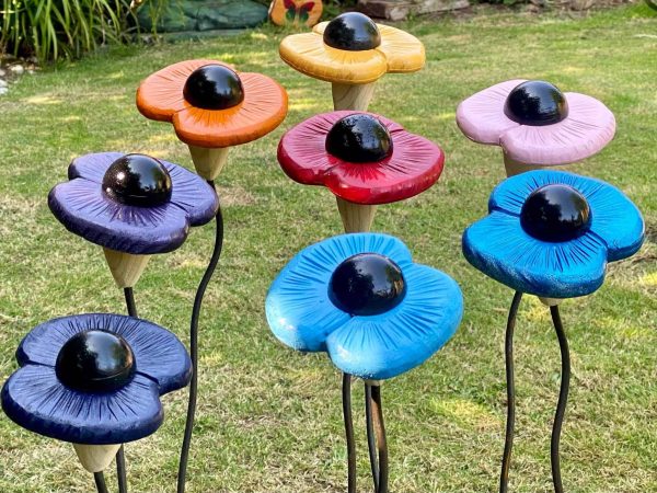 8 OF OUR POPPY SCULPTERS, each one made from wood with metal stems made to mimic the look of a real poppy