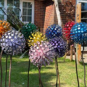 10 of our colourful dandelion sculptures that have been handcraftes using nails to mimic the look of a a read dandelion there are 10 different colours
