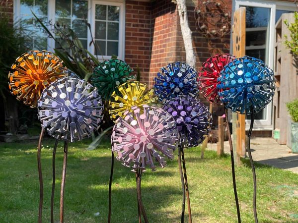10 of our colourful dandelion sculptures that have been handcraftes using nails to mimic the look of a a read dandelion there are 10 different colours